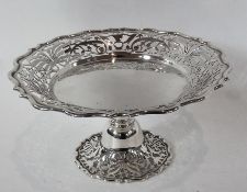 George V silver tazza with pierced fretwork foliate border raised on a pedestal with spreading