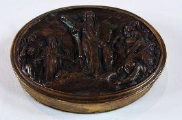 A circular brass snuff box, the cover bronze depicting Moses and the Ten Commandments, width 7cms