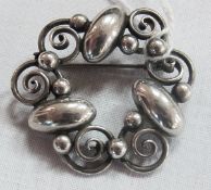 Foreign silver coloured metal Georg Jensen style brooch, oval and scroll pattern, marked SH
