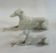 A Vienna porcelain figure of a greyhound seated with crossed legs, length 26cm together with another