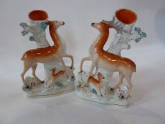 A pair Staffordshire flatback figure group spill vases of deer