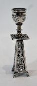A Victorian silver candlestick, raised on a foliate fretwork stand, and short cabriole legs,