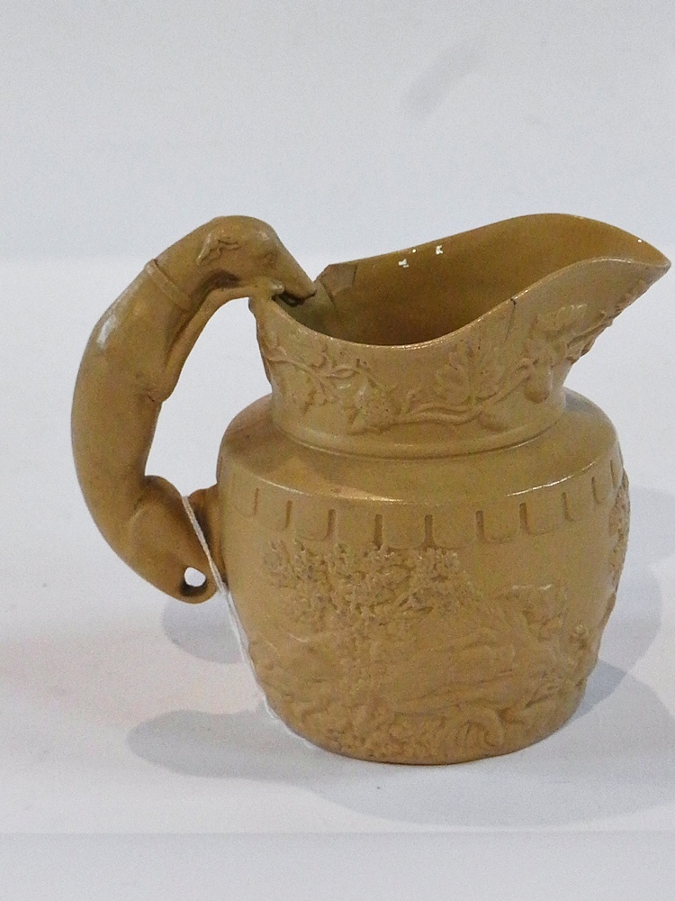 A stoneware jug decorated with greyhound handle and hunting scenes with stag