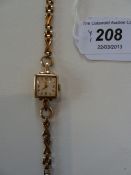 Lady's 9ct gold Longines wristwatch, square, on 9ct cross pattern bracelet