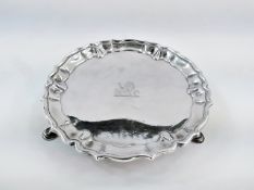 George II silver card tray, circular and having raised ogee border, on three hoof feet, 14cm