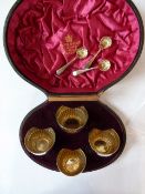 A boxed set of Mappin and Webb four salts, with three spoons, in original box