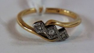 Three-stone diamond crossover ring