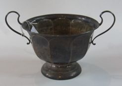 A George V silver two-handled cup, of faceted form, with a raised circular foot, Sheffield 1912,