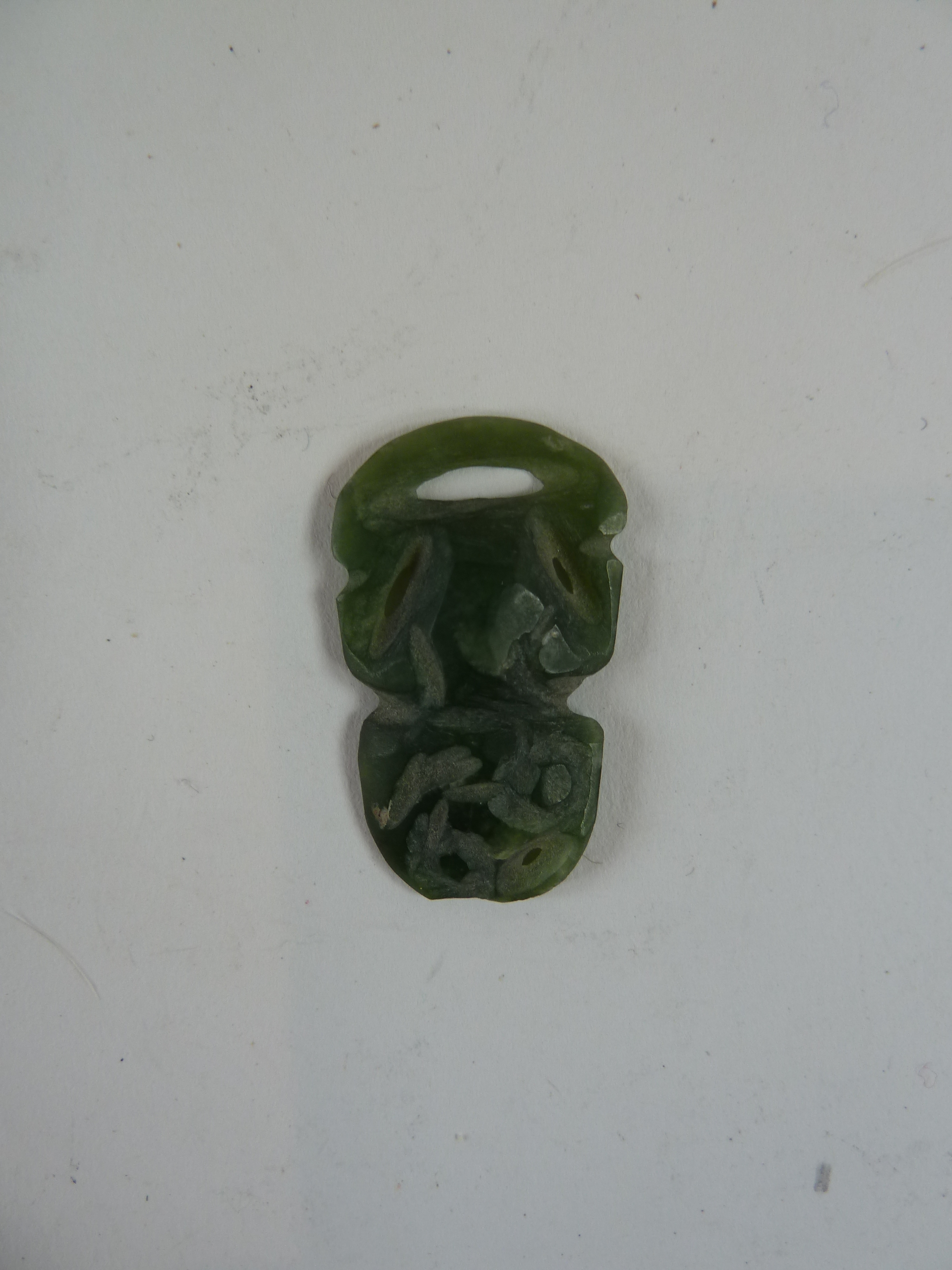 Small carved green jade pendant
