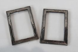 Pair George V silver rectangular photograph frames, with reeded border and trestle stands,