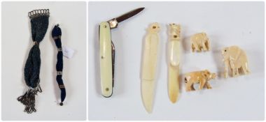 A small collection of carved ivory elephants, a paper knife, pen knife, butter knife etc and two