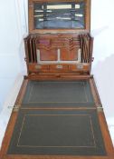 An exceptional oak portable writing/stationery cabinet, the fitted interior with stationery racks,