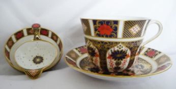 Royal Crown Derby 'Imari' pattern breakfast cup and saucer and a tea strainer with stand