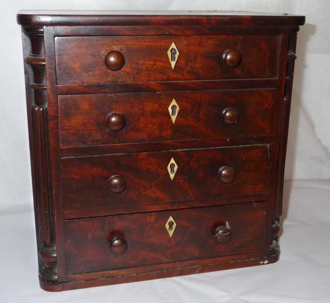 A 19th century miniature mahogany chest, of four drawers each with turned knob handles and bone/