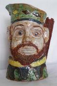 A character jug in the form of a knight with 'castle' handle, 24cm high and a pottery 'Tom Cat'