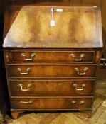 Reproduction mahogany bureau, sloping fall front, cross-banded enclosing fitted interior with pigeon