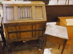 Twentieth century reproduction oak bureau, the linenfold carved and framed panelled sloping front