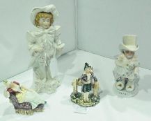 A group of continental figurines, Papa and boy, and two miniature figures of a musician and a