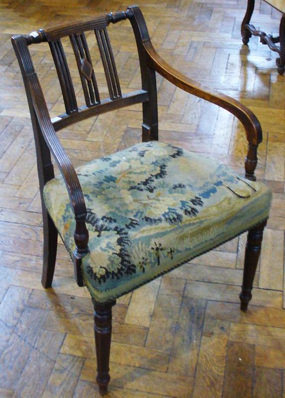 Regency mahogany armchair, with turned reeded crest rail and fretwork splats, the down swept arms to