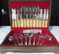Service of EPNS flatware for six persons, including knives in stained wood table top canteen