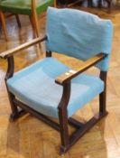 Early twentieth century oak framed open armchair with upholstered back and seat, on square legs