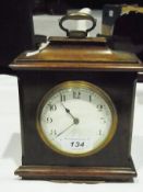 Early 20th century mahogany cased timepiece, having raised pediment with brass loop handle, white