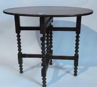 Twentieth century mahogany oval gate-leg occasional table, with turned spiral supports, 68cm wide