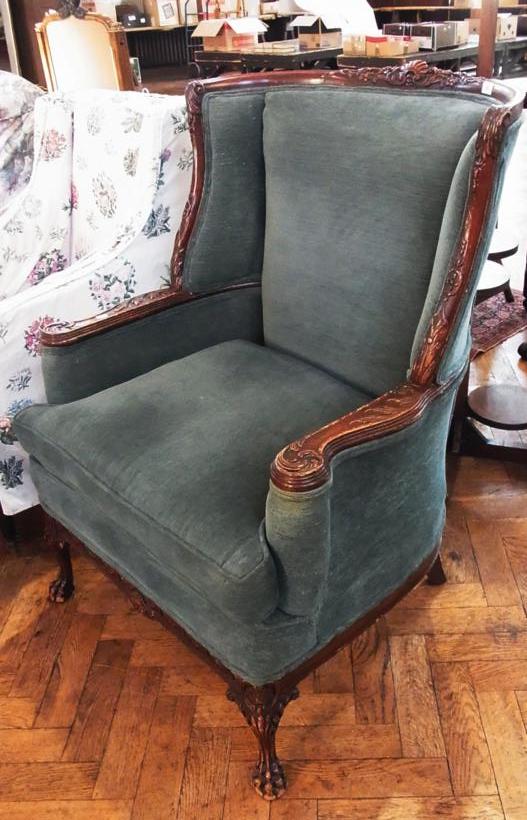 Georgian style carved mahogany frame wing armchair with foliate decoration, green upholstery with