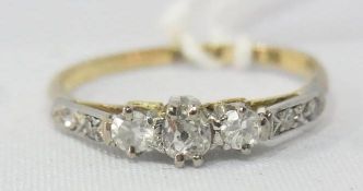 18ct gold three stone diamond ring set with small diamonds to the shoulders