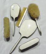 Cream enamel and silver-coloured metal mounted dressing table set, viz:- two hairbrushes, two