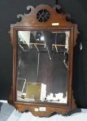 George III style mahogany wall mirror, with scrolled decorated and pierced raised pediment and