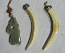 Two animal tooth mounted pendants and an oriental jade-type stone carved pendant