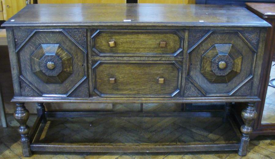 Twentieth century oak sideboard, with two central drawers flanked by pair cupboards, with relief