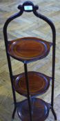 Early twentieth century inlaid mahogany folding three-tier cake stand, with arched top, line inlaid