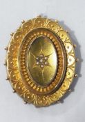 Victorian 9ct gold brooch, oval with seedpearl flowerhead to the centre with filigree scroll border