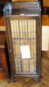 Oak bookcase cabinet, having tray top with leaded door fitted with set Encyclopaedia Britannica,