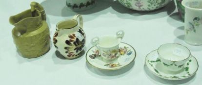 Nineteenth century two-handled English china miniature cup, of ogee form, having ring and scroll