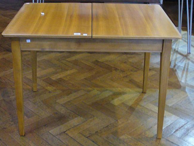 1970s Gordon Russell walnut veneer and hardwood extending dining table, on tapering supports,