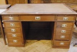 Reproduction stained wood pedestal desk, the top inset with leather, (hold cut through for