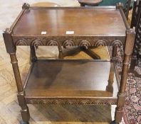 Twentieth century oak two-tier trolley, on carved column supports, on castors 63cm wide