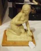 White marble figure of kneeling girl on pale pink marble type plinth base, 23cm high