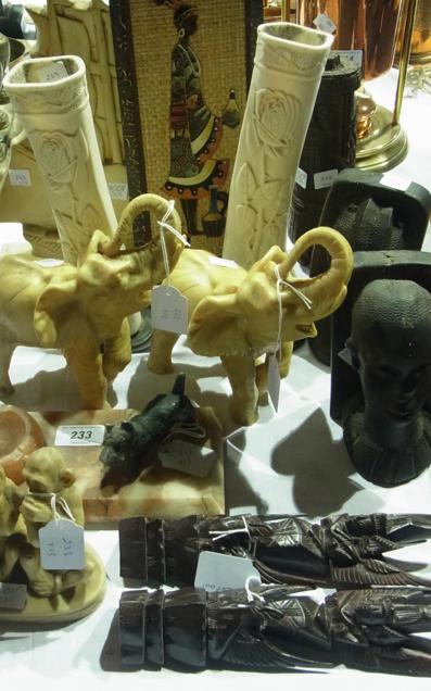 A 1930's ashtray, marble base with a scottie dog, two resin elephants, carved African heads and