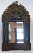 An eighteenth century style Dutch wall mirror with brass foliate scroll work decoration and a faux