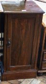 Late Victorian stained walnut pot cupboard, the panelled door enclosing shelf raised on a plinth