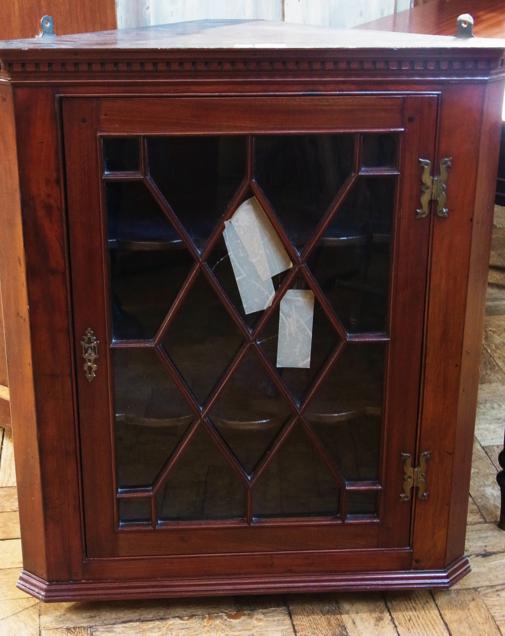 Georgian style mahogany corner cupboard with dental frieze, the astragal glazed door enclosing two