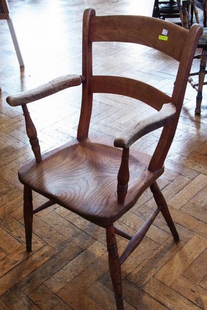 A pair of wheel back Windsor armchairs, spindle backs, solid elm seats, on turned legs united by
