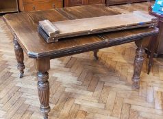 A late Victorian walnut extending dining table with two extra leaves, and wind-out mechanism, on