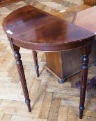 Reproduction mahogany veneered demi-lune side table on turned fluted legs, width 74cms