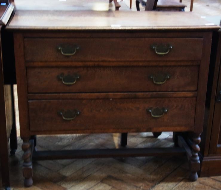 Twentieth century oak chest, with moulded edge top, three graduated drawers, raised on turned spiral