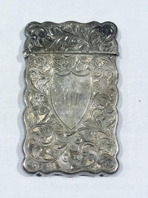 Edwardian silver card case, the scalloped sides foliate scroll engraved, Birmingham 1905